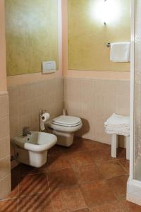 a bathroom with a toilet and a sink at Villa Nottola in Montepulciano