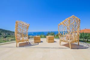 a couple of chairs sitting on top of a patio at Highclere Hotel and Spa in Faralya