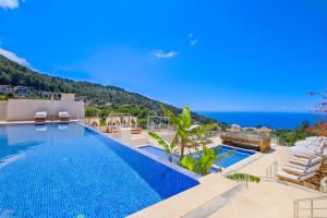 a swimming pool with a view of the ocean at Highclere Hotel and Spa in Faralya
