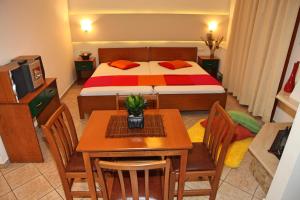 a bedroom with a bed and a table and chairs at Vaya Apartments & Studios in Platamonas