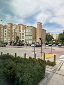 a parking lot with buildings and a street with cars at Cosy home near metro station in Dubai