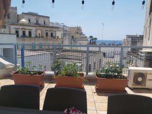 a balcony with pots of plants on a balcony at La portuense in Castro di Lecce