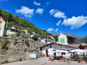 a village on a mountain with a building at Ostello del Parco di Cicogna in Cicogna