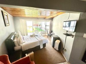 a bedroom with a bed and a tv in a room at Horizon Bed and Breakfast in Roodepoort