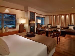 a bedroom with a bed and a living room at The Setai, Miami Beach in Miami Beach