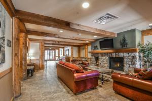 a living room with leather furniture and a fireplace at Dakota Lodge 8455 in Keystone