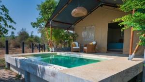 a swimming pool in the middle of a house at Elephant View Camp in Ban Huai Thawai