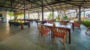 a group of tables and chairs in a restaurant at Elephant View Camp in Ban Huai Thawai