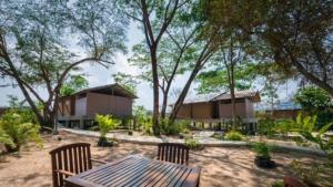 a resort with a table and chairs and trees at Elephant View Camp in Ban Huai Thawai