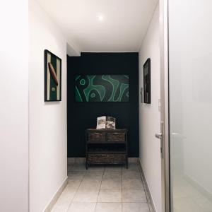 a hallway with a green painting on a wall at Poolside Villa in Johannesburg