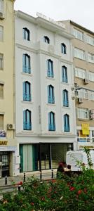 a white building with windows and flowers in front of it at KRALICE HOTEL in Istanbul