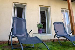 zwei Stühle im Gras vor einem Haus in der Unterkunft Vienna Experience in Wien