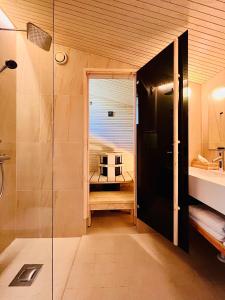 a bathroom with a shower and a glass door at Nova Skyland Hotel in Rovaniemi