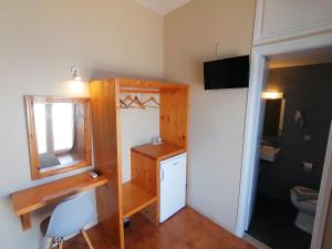 a bathroom with a toilet and a sink and a mirror at Perdika Mare Guesthouse in Perdika