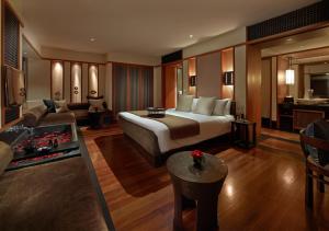 a hotel room with a bed and a living room at The Setai, Miami Beach in Miami Beach