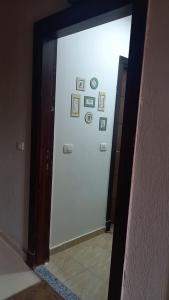 a hallway with a white door with pictures on it at قرية جراند هيلز الساحل الشمالي للعائلات فقط Grand Hills North Coast كود E45 in Dawwār ‘Abd Allāh