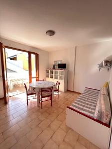 a room with a table and chairs and a kitchen at Bilo Giacomo a 150 m dal mare in Marcelli