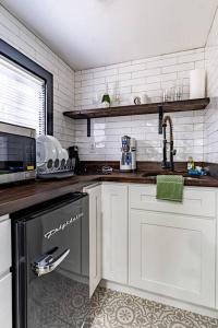 a kitchen with a sink and a dishwasher at Luxurious and Cozy Cabin in a Rural setting - 8 