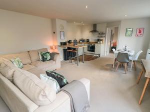a living room with a couch and a table and a kitchen at The Annexe in Bridlington