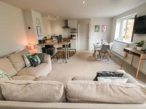 a living room with a couch and a dining room at The Annexe in Bridlington