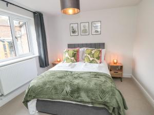 a bedroom with a large bed and a window at The Annexe in Bridlington