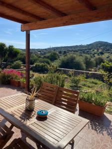a wooden table with two chairs on a patio at Casetta Vittoria in Palau