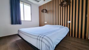 a small bed in a room with a window at Signal Appartments in Abidjan