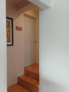 a hallway with stairs and a sign on the wall at Botleng Guest House in Boqate