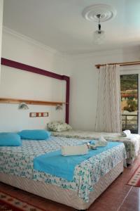 a bedroom with two beds with towels on them at Rose Hotel B&B in Patara