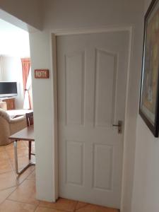 a white door in a living room with a table at Botleng Guest House in Boqate