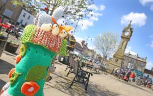 a sock monkey with stuffed animals on a city street at Thirsk Stays - Bakery Cottage in Thirsk
