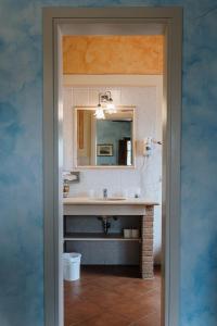 a bathroom with a sink and a mirror at Villa Nottola in Montepulciano