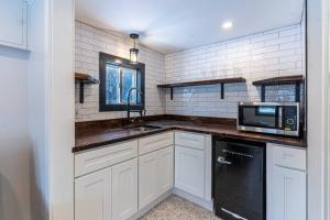 a kitchen with a sink and a microwave at Luxurious and Cozy Cabin in a Rural Setting #16 