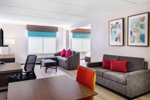 a living room with a couch and a table at Wingate by Wyndham Atlanta-Duluth in Duluth