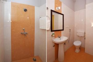 a bathroom with a shower and a sink and a toilet at Dayal Hotel in Lucknow