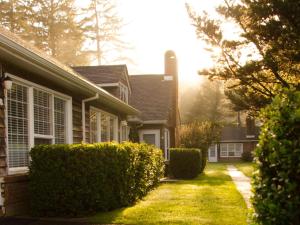 a house with hedges in front of a house at Ecola Creek Lodge in Cannon Beach