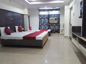 a bedroom with a large bed and a window at Dayal Hotel in Lucknow