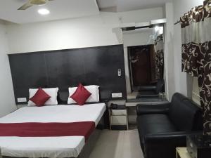 a hotel room with a bed and a couch at Dayal Hotel in Lucknow
