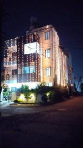 a large building with lights on it at night at SUKH PALACE in Shamsgarh