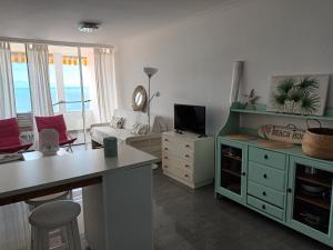 a living room with a kitchen and a living room with a couch at Great oportunity Costa Adeje Holiday apartment first sea line Free Wifi in Callao Salvaje
