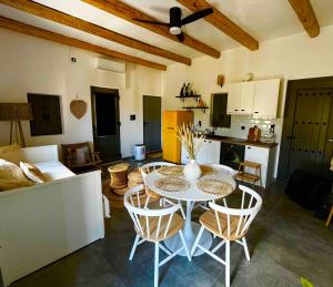 a kitchen and dining room with a table and chairs at Pyrrichos Stone House in Pírrikhos