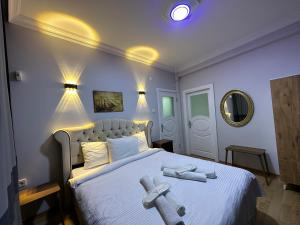 a bedroom with a large bed with two crosses on it at İSTANBLUE TAKSİM APART HOTEL in Istanbul