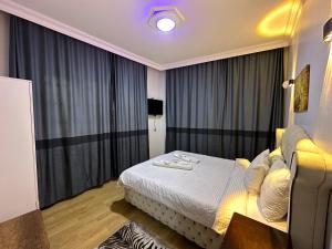a hotel room with a bed and large windows at İSTANBLUE TAKSİM APART HOTEL in Istanbul