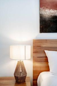 a lamp sitting on a table next to a bed at Relax in 2B2B Chateau near UQ with Parking+Balcony in Brisbane