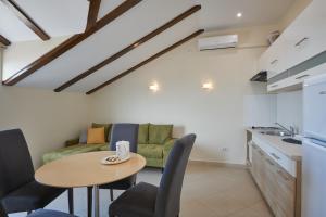 een keuken en eetkamer met een tafel en een bank bij Dubrovnik View Apartments in Dubrovnik