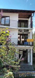 Uma casa branca com um cartaz que diz "Villa Gerry" em Pensiunea Vila Geany SRL em Băile Herculane