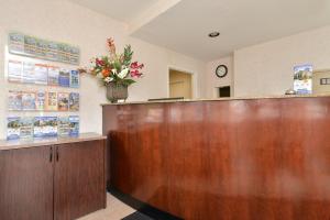 a lobby with a reception desk with a vase of flowers at Americas Best Value Inn San Jose in San Jose