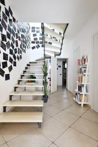 a staircase in a house with photographs on the wall at Al Vicoletto - Genuine Hospitality in Tortolì