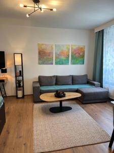 a living room with a couch and a table at Friendly Space Apartment in Graz +15 photos