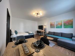 a living room with a couch and a table at Friendly Space Apartment in Graz